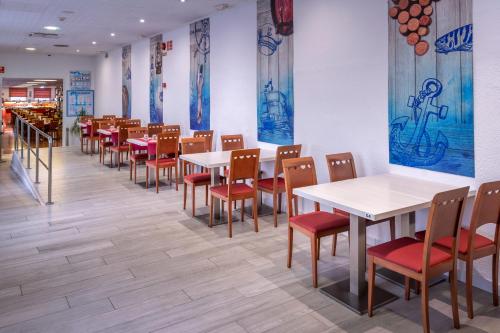 a row of tables and chairs in a restaurant at GHT Balmes, Hotel-Aparthotel&SPLASH in Calella