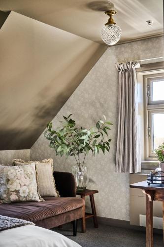 a living room with a couch and a window at Stangeland Gard in Austevoll