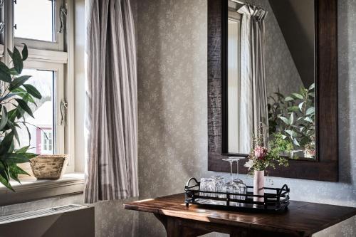 a room with a wooden table with flowers on it at Stangeland Gard in Austevoll