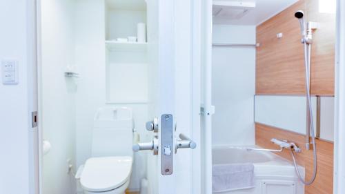 a bathroom with a toilet and a sink at 9Stay文京大塚 in Tokyo