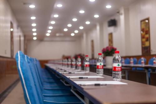 a row of bottles of water sitting on a table at Xingshengjiu Courtyard Hotel Pingyao in Pingyao