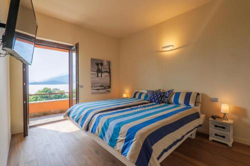 a bedroom with a bed and a large window at Casa Bella Vista in Laveno