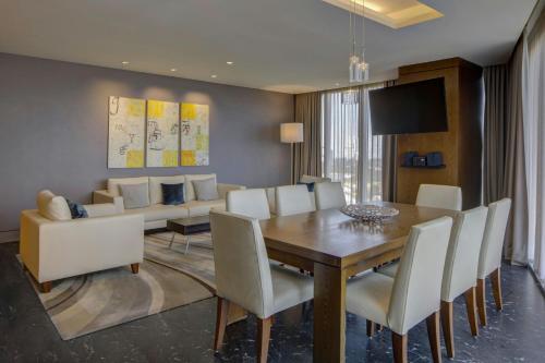 a dining room with a table and a couch at The Westin Santa Fe, Mexico City in Mexico City