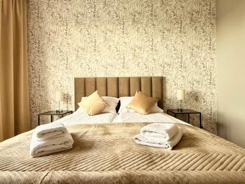 a bedroom with a large bed with two pillows on it at Uniwersytecki by Rentoom in Toruń