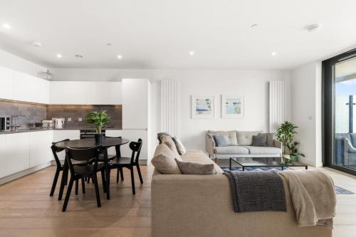 a living room with a couch and a table at Spacious modern 1 bed Apartment. in London
