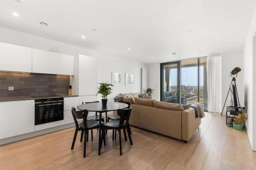a living room with a couch and a table at Spacious modern 1 bed Apartment. in London