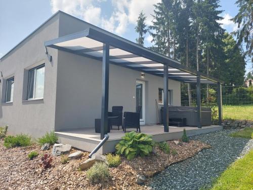 a house with awning over a patio at Tópart Apartmanok in Nagylengyel
