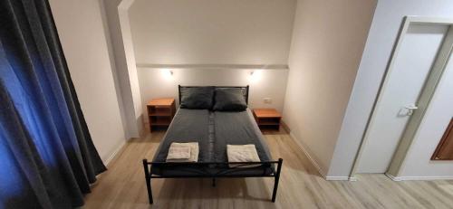 a small room with a bed in a room at Pension Wolf in Gersdorf