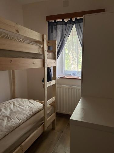 a bedroom with two bunk beds and a window at Bohinj Countryside House in Bohinjska Bistrica