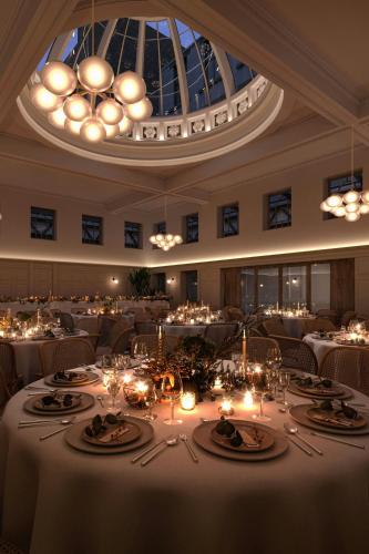 a large dining room with a table with candles at AC Hotel by Marriott Glasgow in Glasgow