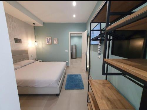 a bedroom with a bed and a bunk bed with a ladder at Playa-degli-Angeli-LEVANTE in Gabicce Mare