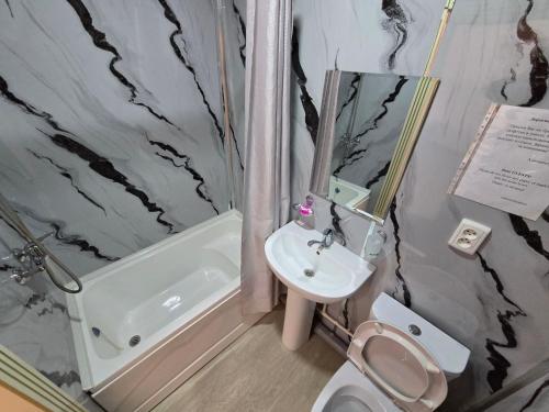 a bathroom with a sink and a toilet and a shower at Donish Hotel in Bukhara