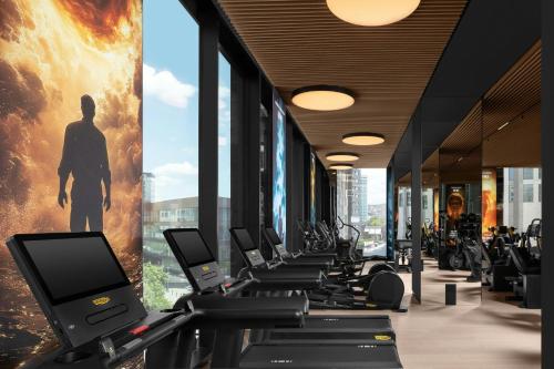 a row of treadmills in a gym with a large window at Courtyard by Marriott Prishtina in Pristina