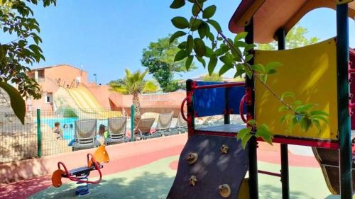 a playground with a pretend play area with at Appartement 4 étoiles - Parc aquatique - ccaa0ai in Bormes-les-Mimosas