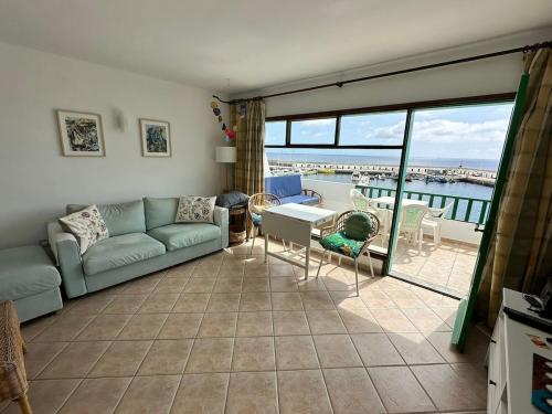 a living room with a couch and a table at Roca Negra in Puerto del Carmen