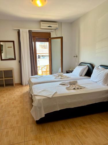 a bedroom with a large bed with towels on it at Hotel Magnolia in Loutra Edipsou