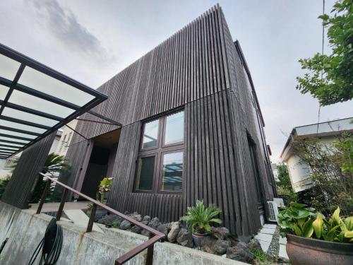 a wooden house with a gambrel roof at KAMAKURA Beach House in Kamakura