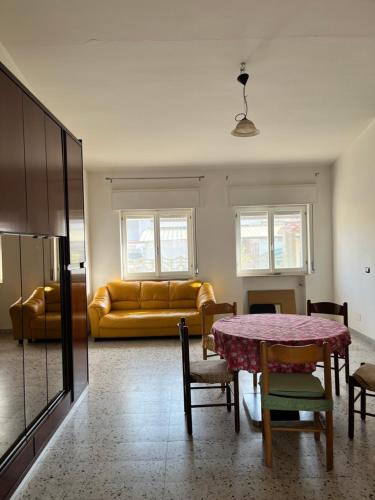 a living room with a table and a couch at Casa vacanze Metauria in Gioia Tauro
