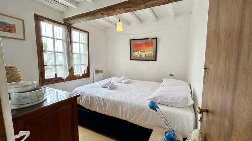 Giường trong phòng chung tại Chez Tata – Maison de Vacances Authentique au Cœur du Crotoy