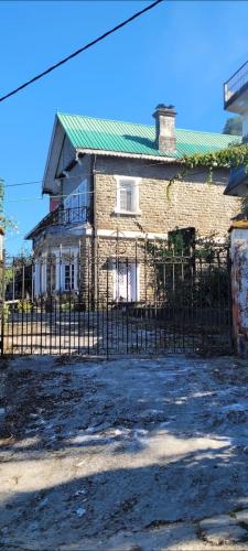 an old brick house with a fence in front of it at SAABY HoMESTAY in Kurseong
