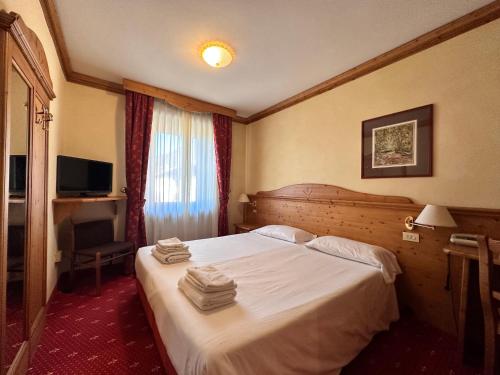 Postel nebo postele na pokoji v ubytování Hotel Alpi - Foza