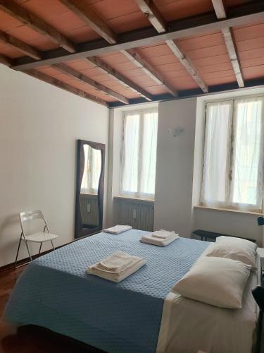 a bedroom with a bed with two towels on it at A casa di Raffaella in Parma