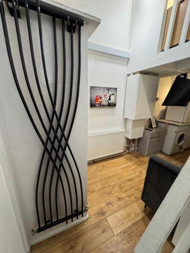 a room with a door with black stripes on the wall at Duplex Studio 3 minute drive from Luton airport in Luton
