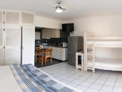 a kitchen and dining room with a table in it at Gracelands Beach Lodge in Ramsgate