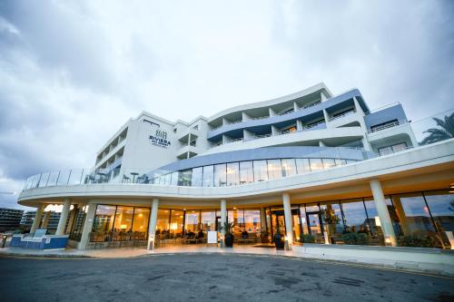 a large building with a lot of windows at Riviera Spa Resort - Adults Only in Mellieħa