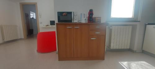 a room with a wooden cabinet with a television on it at Casa San Giovanni, apartment in the center in Borgomanero