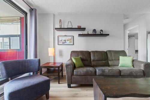a living room with a couch and a table at Suite near Downtown, BMO, Stampede, Free Parking in Calgary