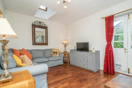 a living room with a couch and a television at New Town Cottage in Edinburgh