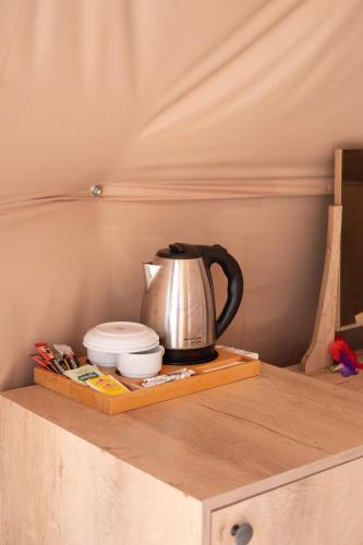 a tea kettle and dishes on a wooden shelf at Kabak Freedom Deluxe Hotel in Faralya