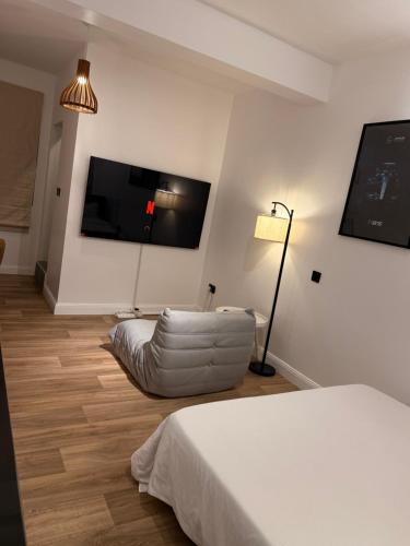 a living room with a couch and a flat screen tv at Iris by kisali in Dar es Salaam