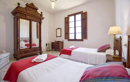 a hotel room with two beds and a mirror at Villa Son Granada Llucmajor in Llucmajor