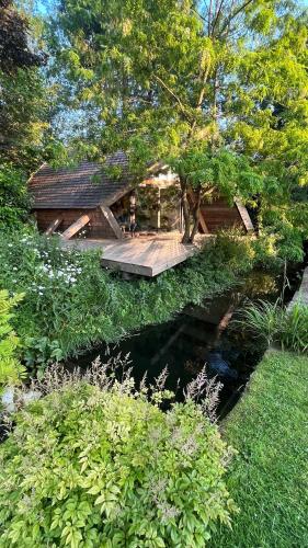 a wooden bridge over a pond in a garden at Island A-Frame in Winchester