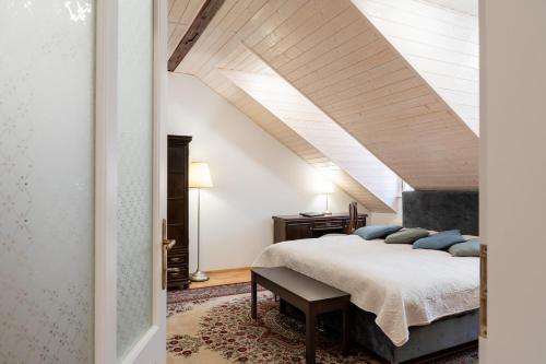 a bedroom with a king sized bed in a attic at Spa Jewel - Stylish Flat in the Center! with Sauna in Karlovy Vary