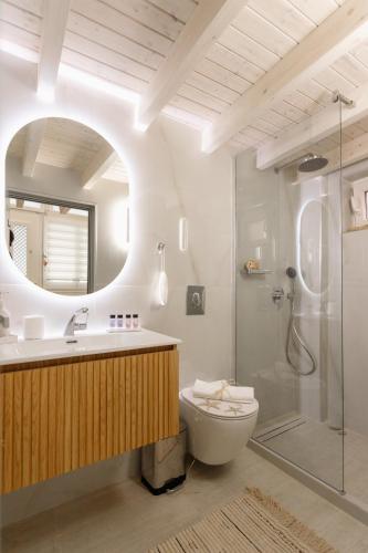 a bathroom with a shower and a toilet and a sink at Agnes Loft at Campiello in Corfu