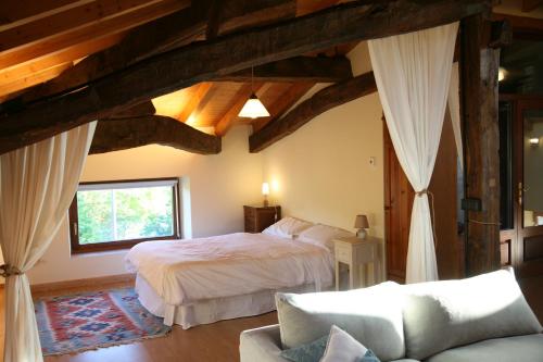 a bedroom with two beds and a couch at Biendella El Desván 
