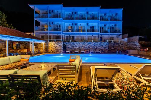 a pool on a cruise ship at night at Hotel Nereides in Patitiri
