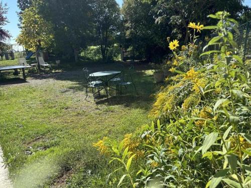 a picnic table and a bench in a park at Paloumat in Larbey