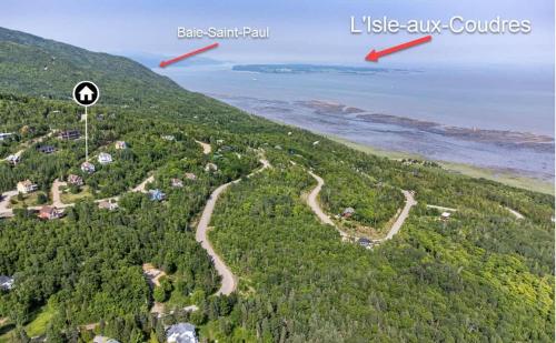 an aerial view of a hill with the ocean in the background at L'Audacieux - SPA, Billard, Poker, Arcade, fleuve, l'évasion VIP in Petite-Rivière-Saint-François