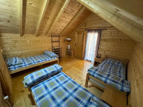 a room with two beds in a log cabin at Gusinje View in Gusinje