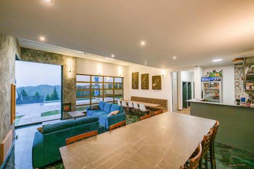 a living room with a large table and a dining room at Vila Natalijina Ramonda in Banja Luka