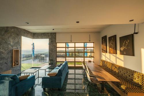 a living room with blue couches and a table at Vila Natalijina Ramonda in Banja Luka