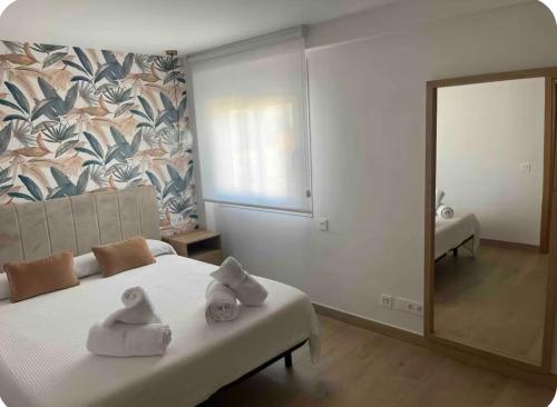 a bedroom with a bed with towels on it at Moderno APARTAMENTO CÉNTRICO EN MARBELLA in Marbella