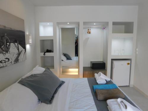 a bedroom with a bed with towels on it at Perissa South Beach Suites in Perissa