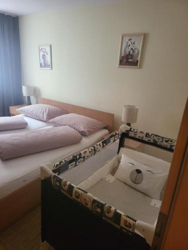 a hotel room with two beds and a box at HOTEL RITTERS WEINSTUBEN kaffe restoran MERSEBURG in Merseburg