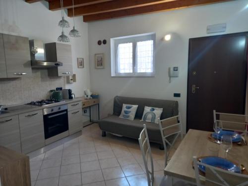 a kitchen and living room with a couch and a table at Chalet sul Mare in Ladispoli
