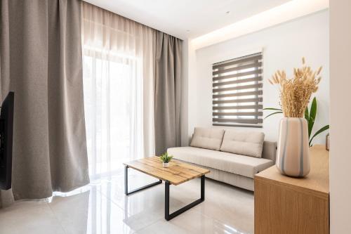 a living room with a couch and a table at Unicos City Suites in Kos Town